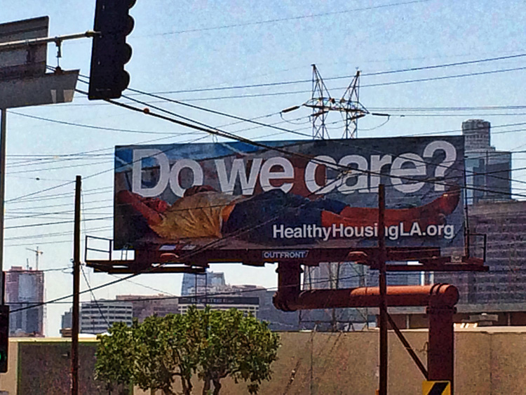 Photo of a billboard that says "Do we care?"