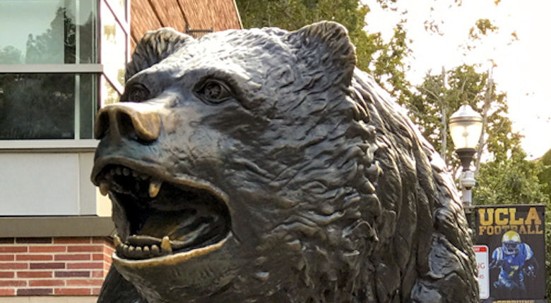 Author's son poses by the UCLA bruin bear statue.