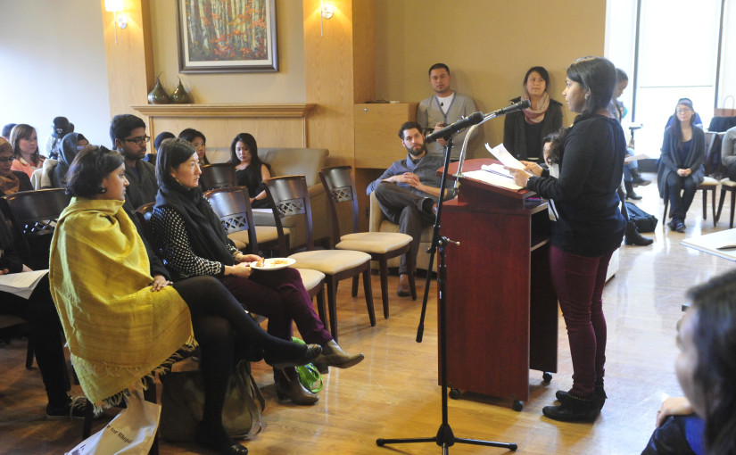 Shiromi presenting her story at the Second Annual Reading of On the Move in April 2014.